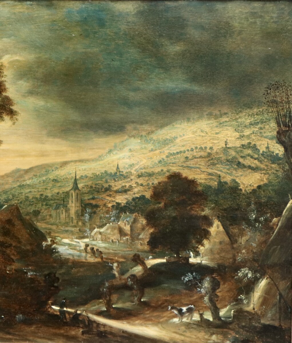 A hilly landscape with a farmhouse at left