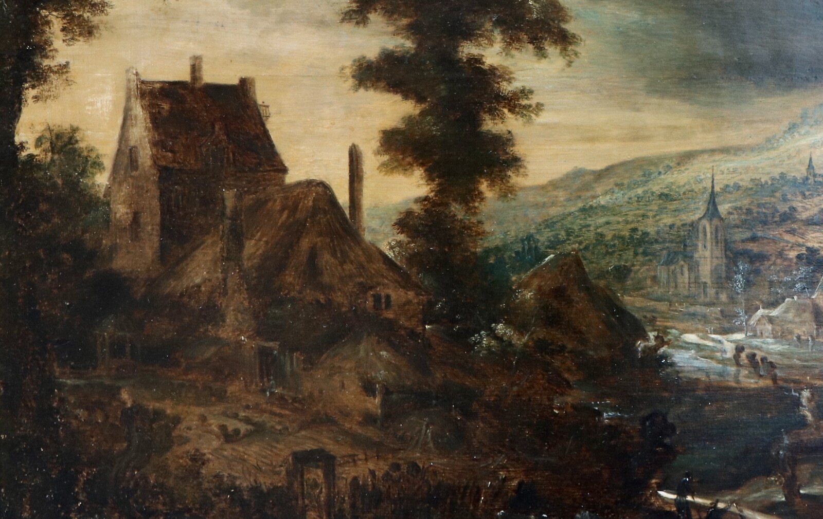 A hilly landscape with a farmhouse at left