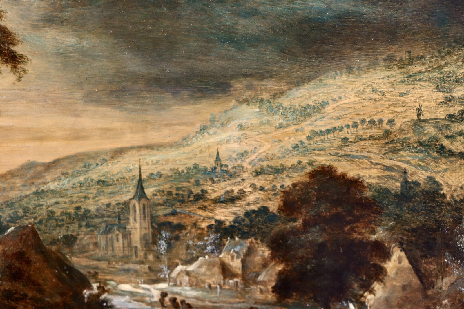 A hilly landscape with a farmhouse at left