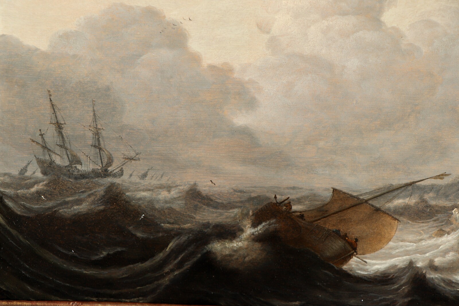 Ships on a rough sea near a rocky coast